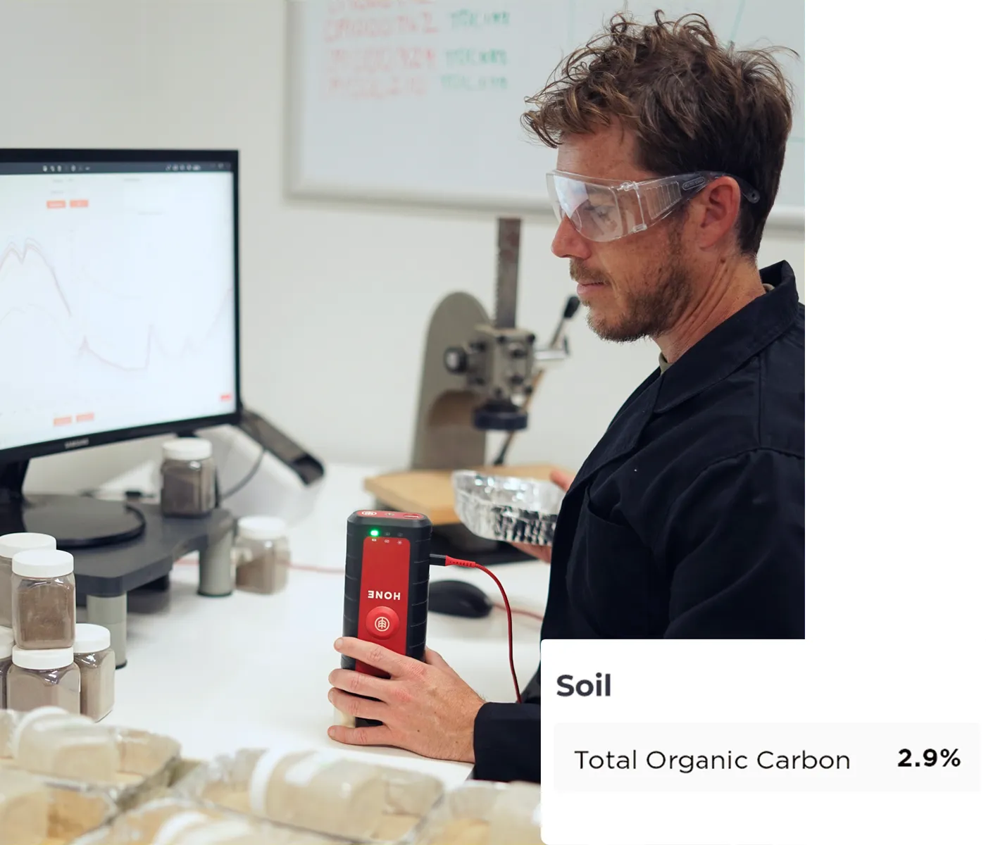A Hone scientist scanning a prepared soil sample at the Broadmeadow laboratory, with a total organic carbon result of 2.9 per cent on screen
