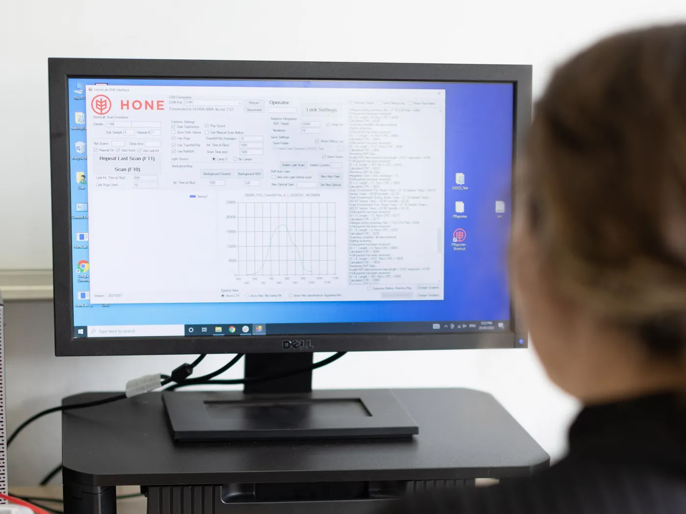 A Hone analyst at a desk reviewing instrument data on screen